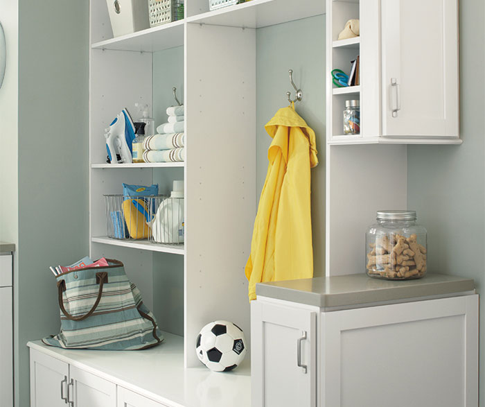 Laundry room cabinets in painted white Maple by Aristokraft Cabinetry