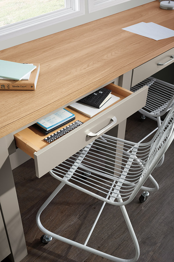 open desk drawer with white chair under table