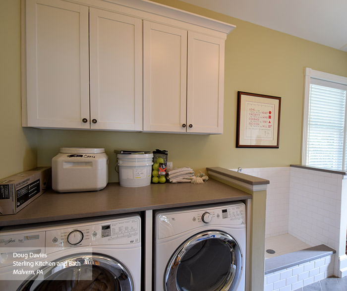 Laundry room with white wall cabinets in the Brellin laminate door style